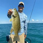 Angler with smallmouth and fishing rod img5308