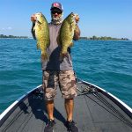 Man with 2 smallmouth bass img0552