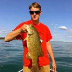 Young angler with smallmouth bass img0509